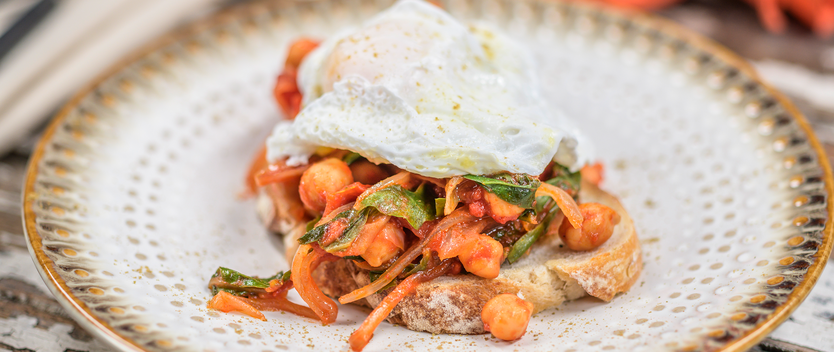 Poached Egg with Chick Peas and Chard over Garlic Toast